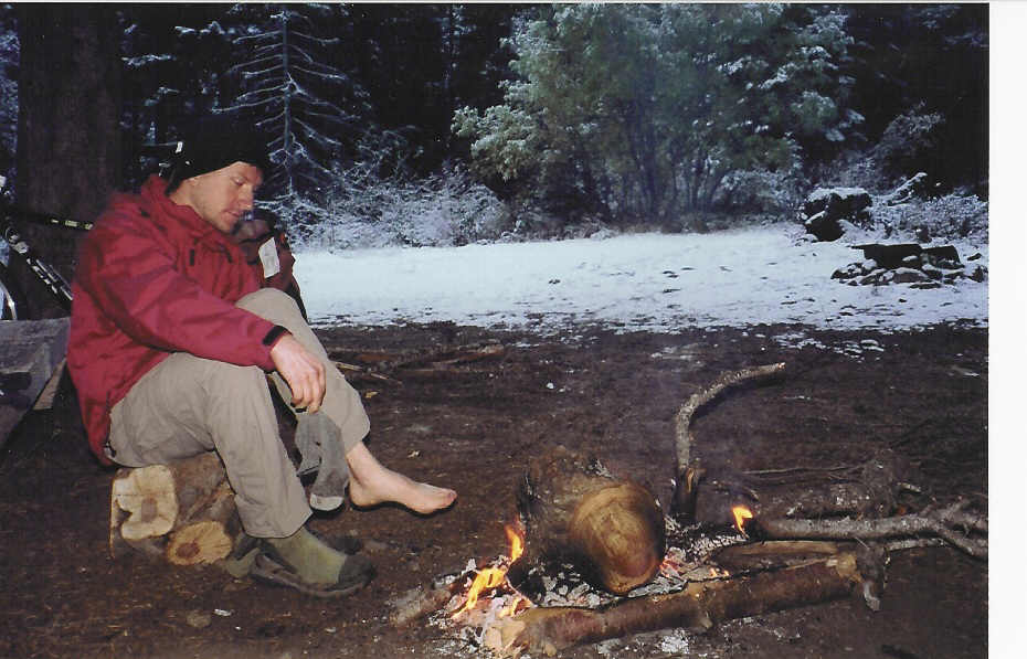 Joe warming cold feet by a fire.